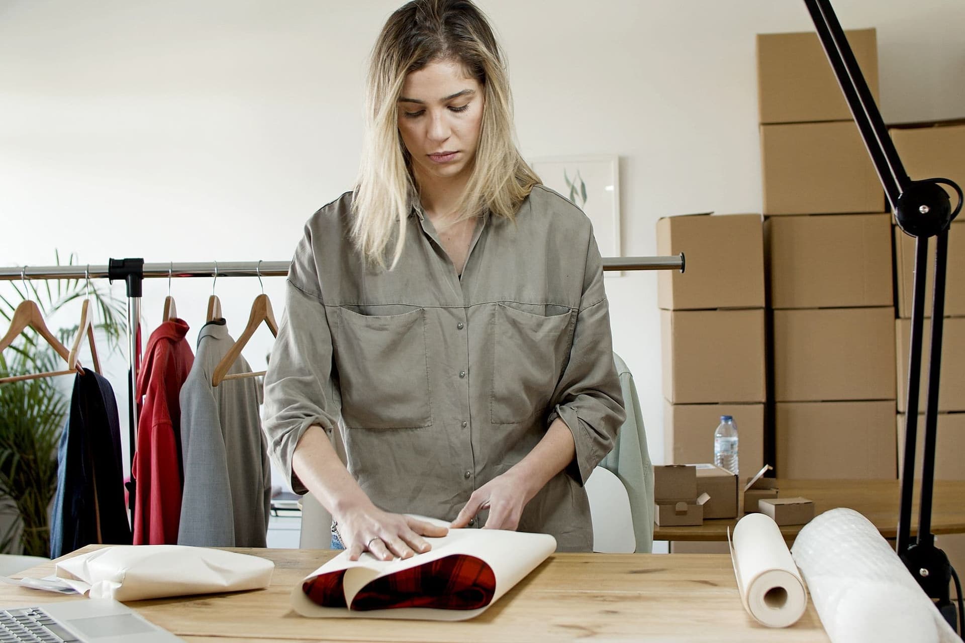 Woman packing clothes for online orders