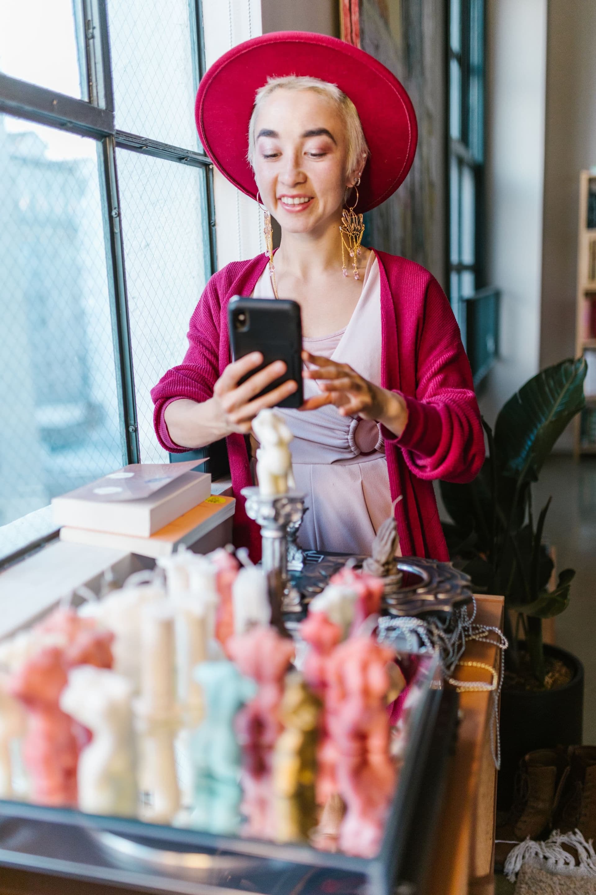 Woman photographing products for her small business with her phone